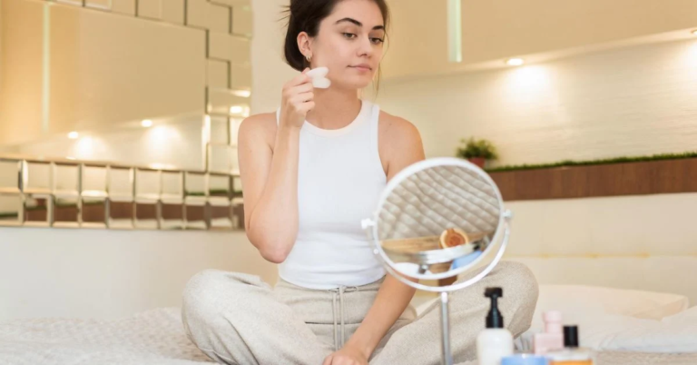 a beautiful woman applying shiner on her face
